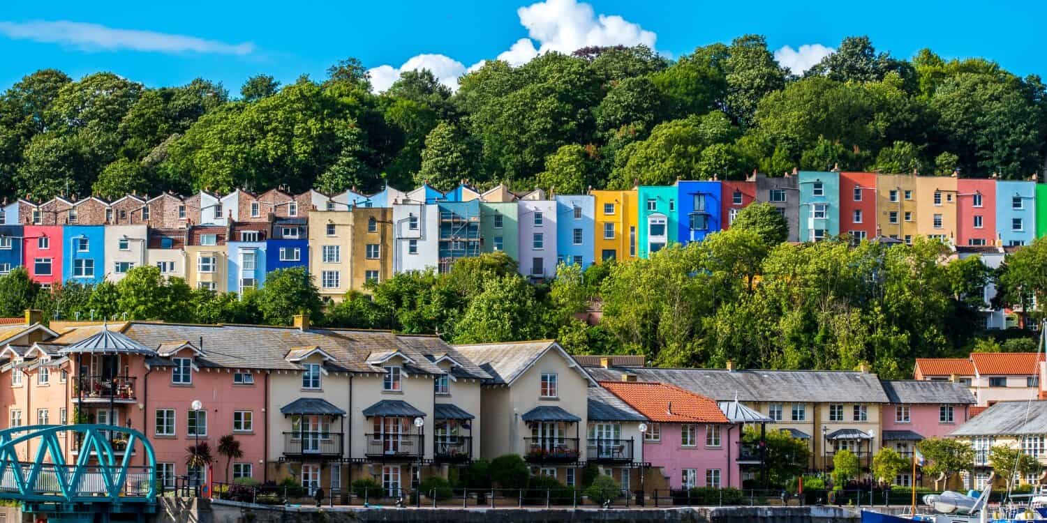 Colourful hillside houses and waterfront buildings in Bristol, a top city to launch a startup in the UK, known for its vibrant community and growing business ecosystem.