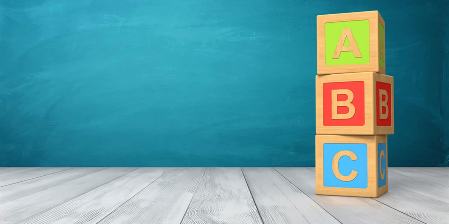 A stack of three A, B and C alphabet blocks with turquoise background - symbolising the concept of multiple share classes.