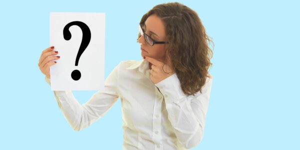 Woman holding a sign with a question mark, looking thoughtfully as she considers how to gather information about a company director.