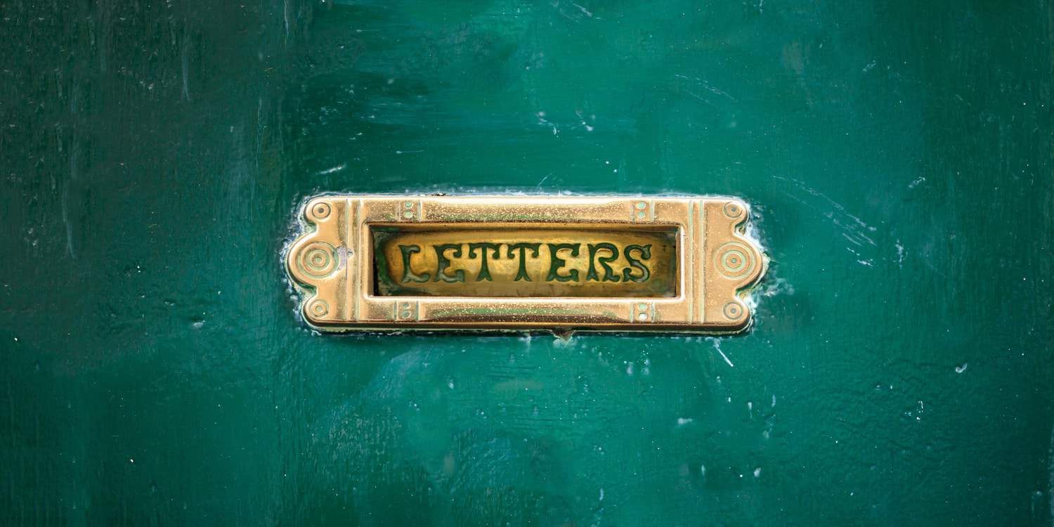 Image of a brass letter plate on a green door, illustrating the purpose of a director's service address.