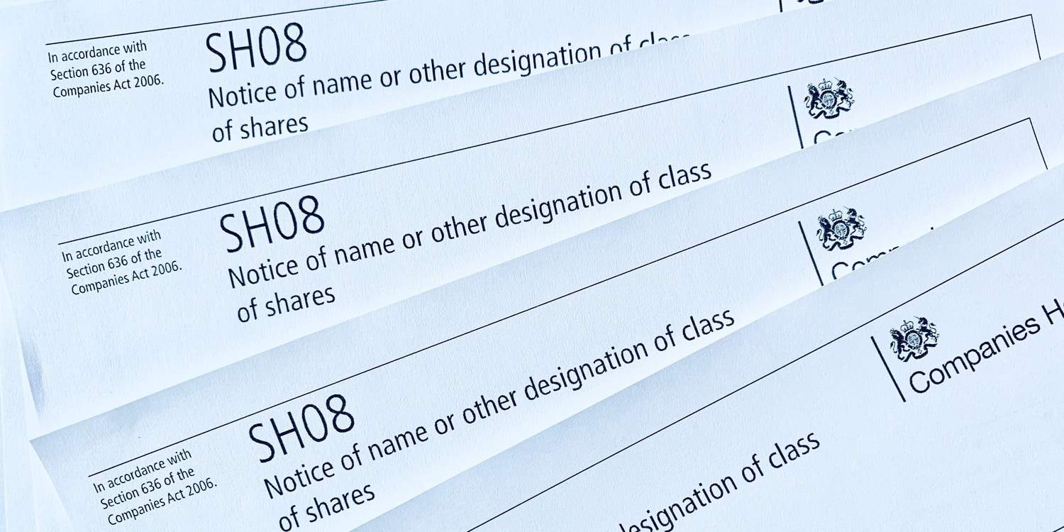 Image of printed copies of Companies House form SH08, which must be completed when a redesignation of shares is carried out.