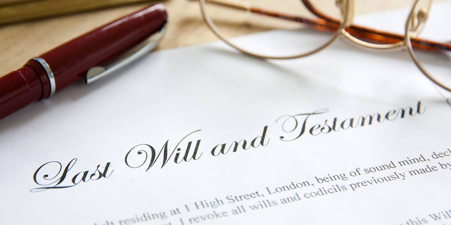 Image of a Last Will and Testament on desk with pen and spectacles.