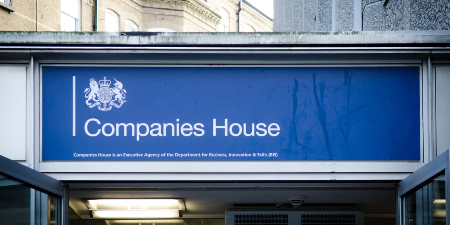 Blue sign with white lettering displaying the name 'Companies House' above Companies House Cardiff's main entrance, showing the agency where a company is required to register a charge.