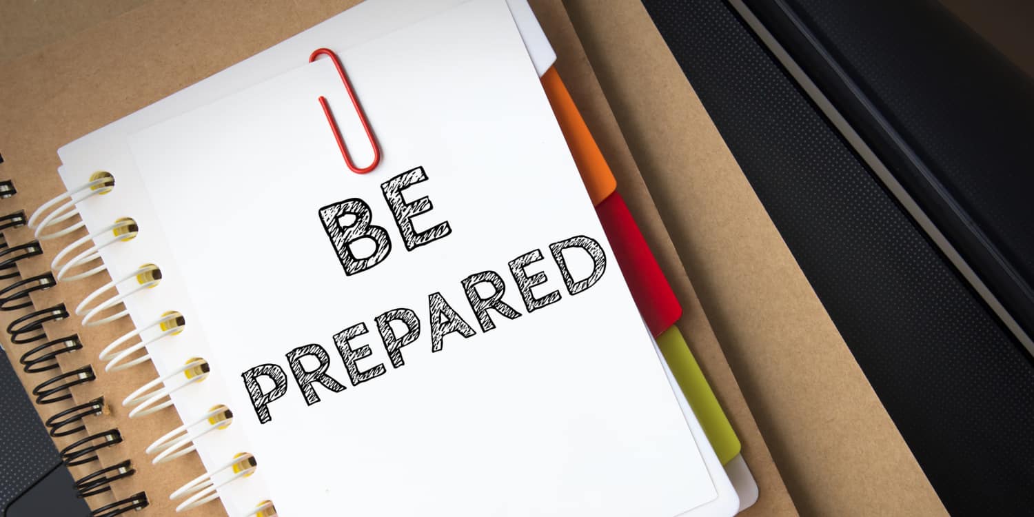 A white note pad with the phrase 'BE PREPARED' written in black ink, illustrating the importance of putting measures in place to deal with the death of a company director.