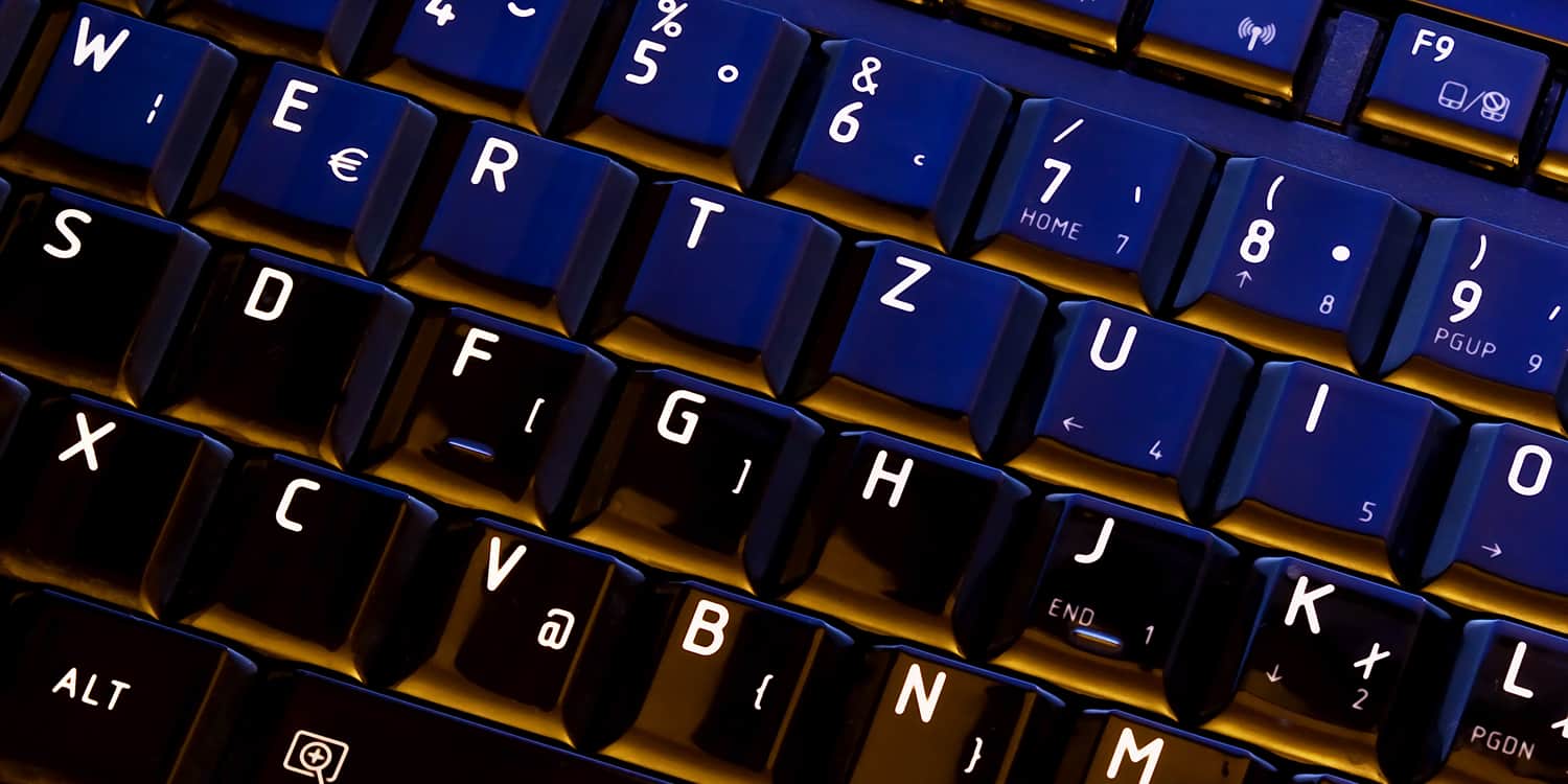 Close-up of a computer keyboard displaying the concept of characters and symbols used in company names.