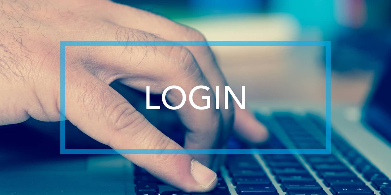 Male hand using a laptop keyboard with 'LOGIN' button overlaid with white text and blue border.