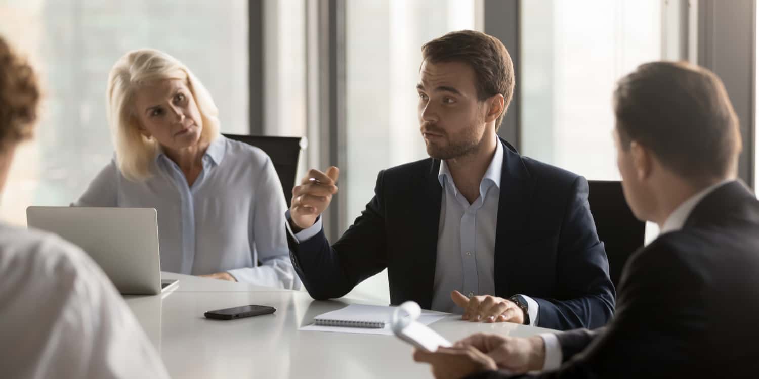 Image of 4 individuals in a business meeting, representing the roles of company shareholders and directors.