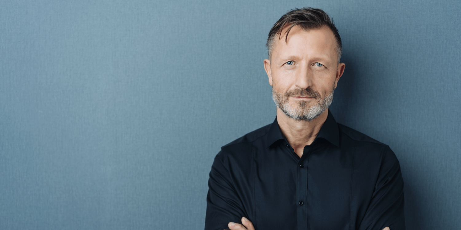 Mature business person in black shirt contemplating retirement.