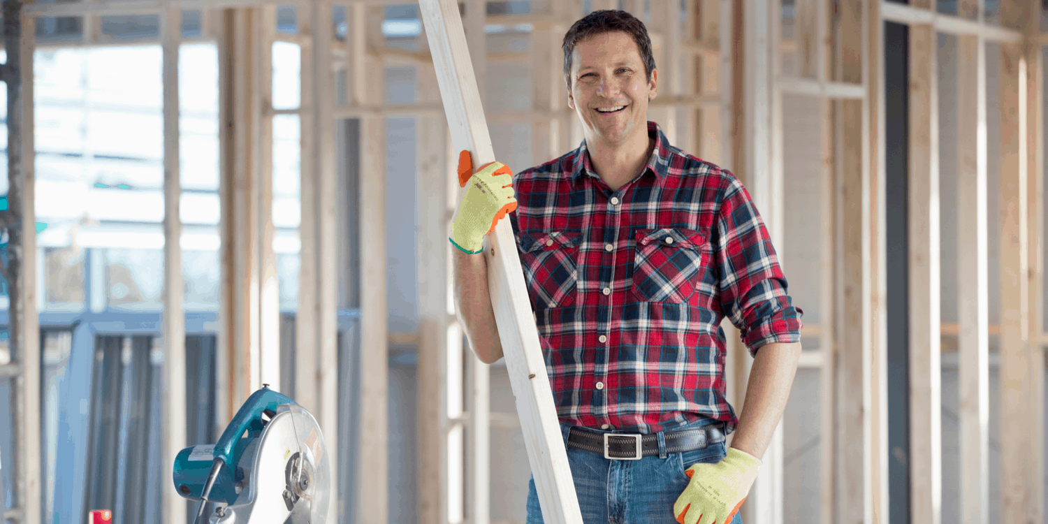 An image of a carpenter on a building site with red check shirt - illustrating the concept of self employed and sole trader.