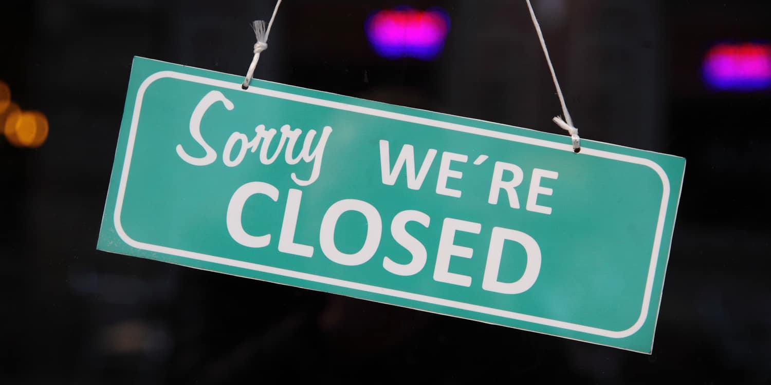 'Sorry we are closed' sign hanging in window.