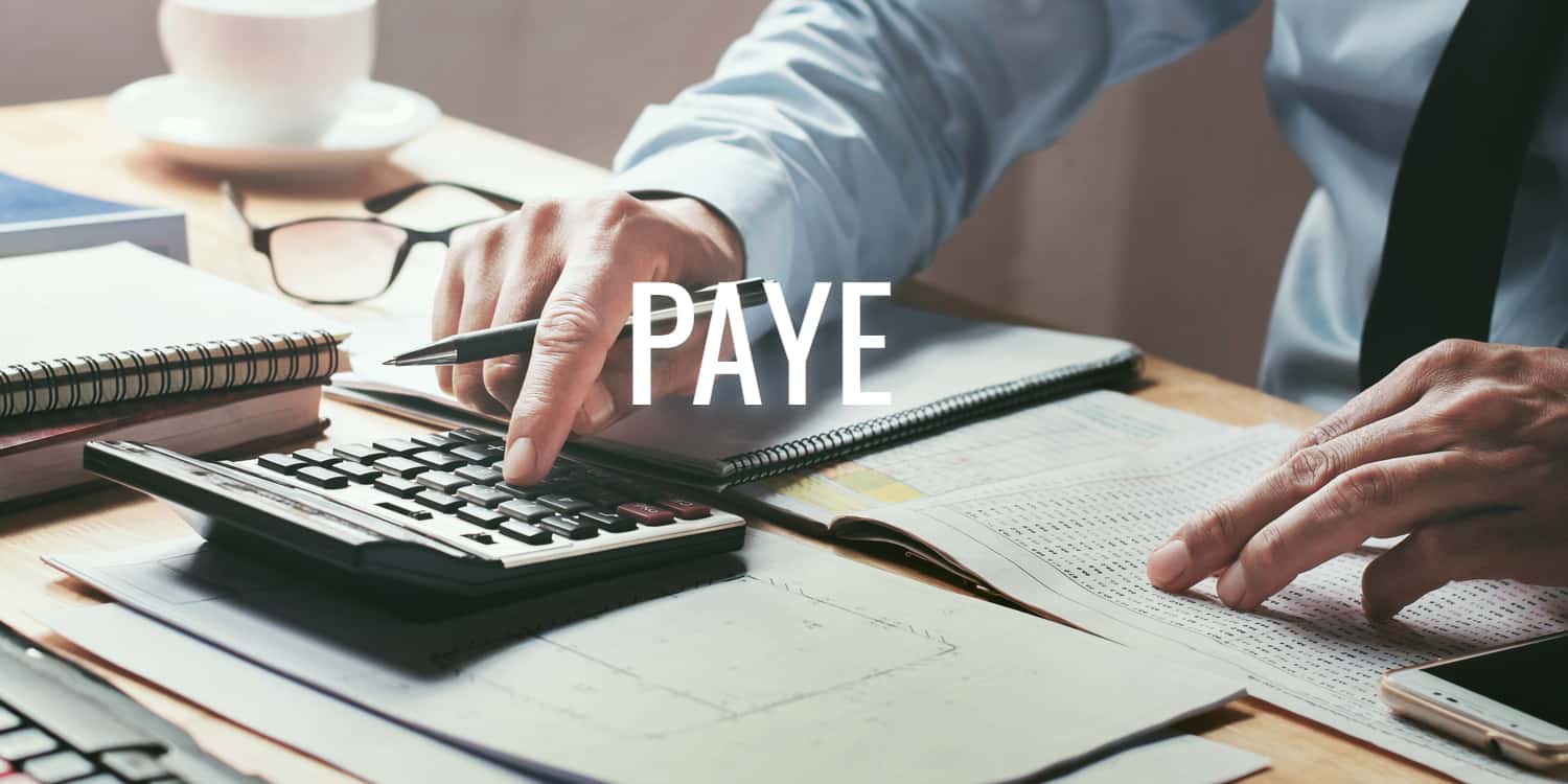 Businessman working at desk office with using a calculator with headline PAYE in white font.