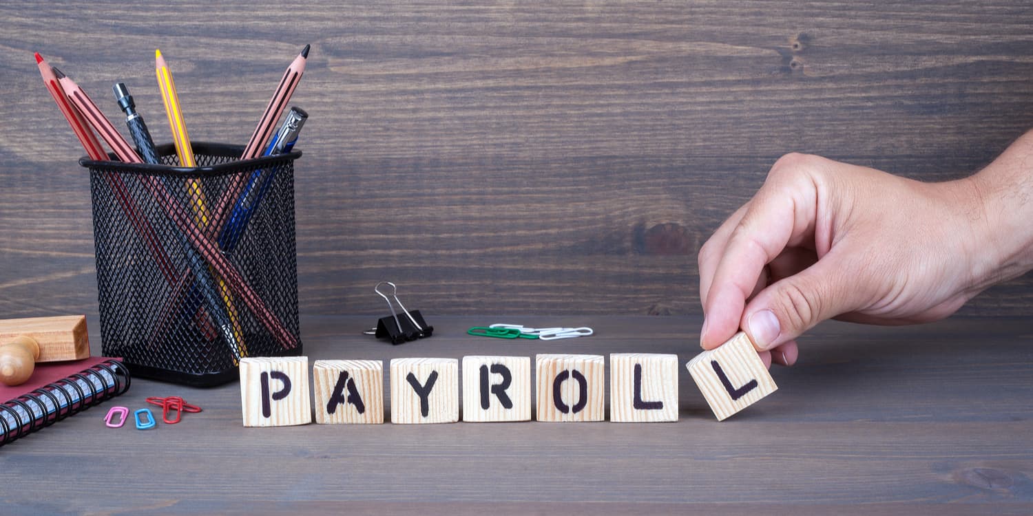 The wprd PAYROLL displayed on wooden blocks.