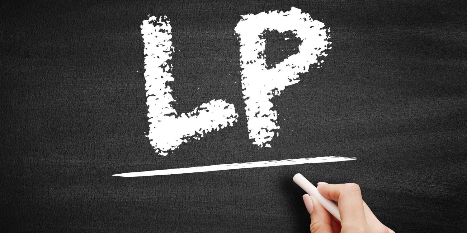 LP written in white chalk on a blackboard. LP is an acronym for limited partnership.