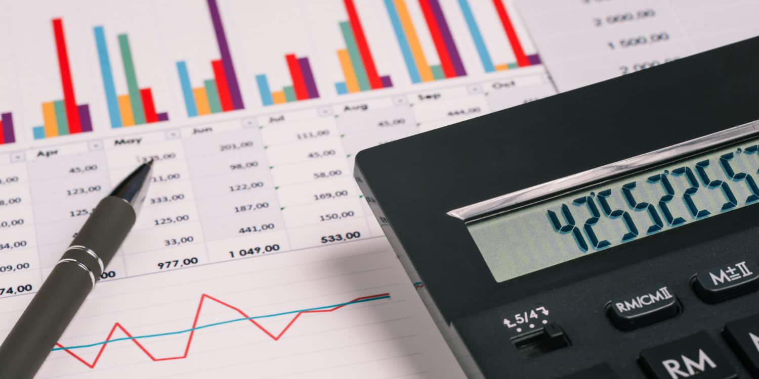 Annual accounts and a calculator on an accountant's desk.