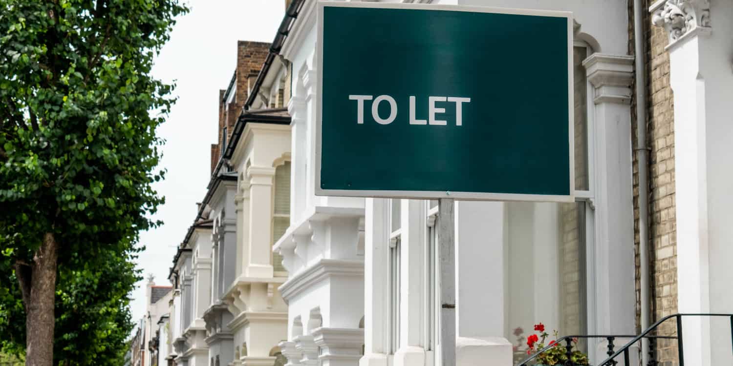 Landlord's TO LET sign outside a row of residential terreced houses.