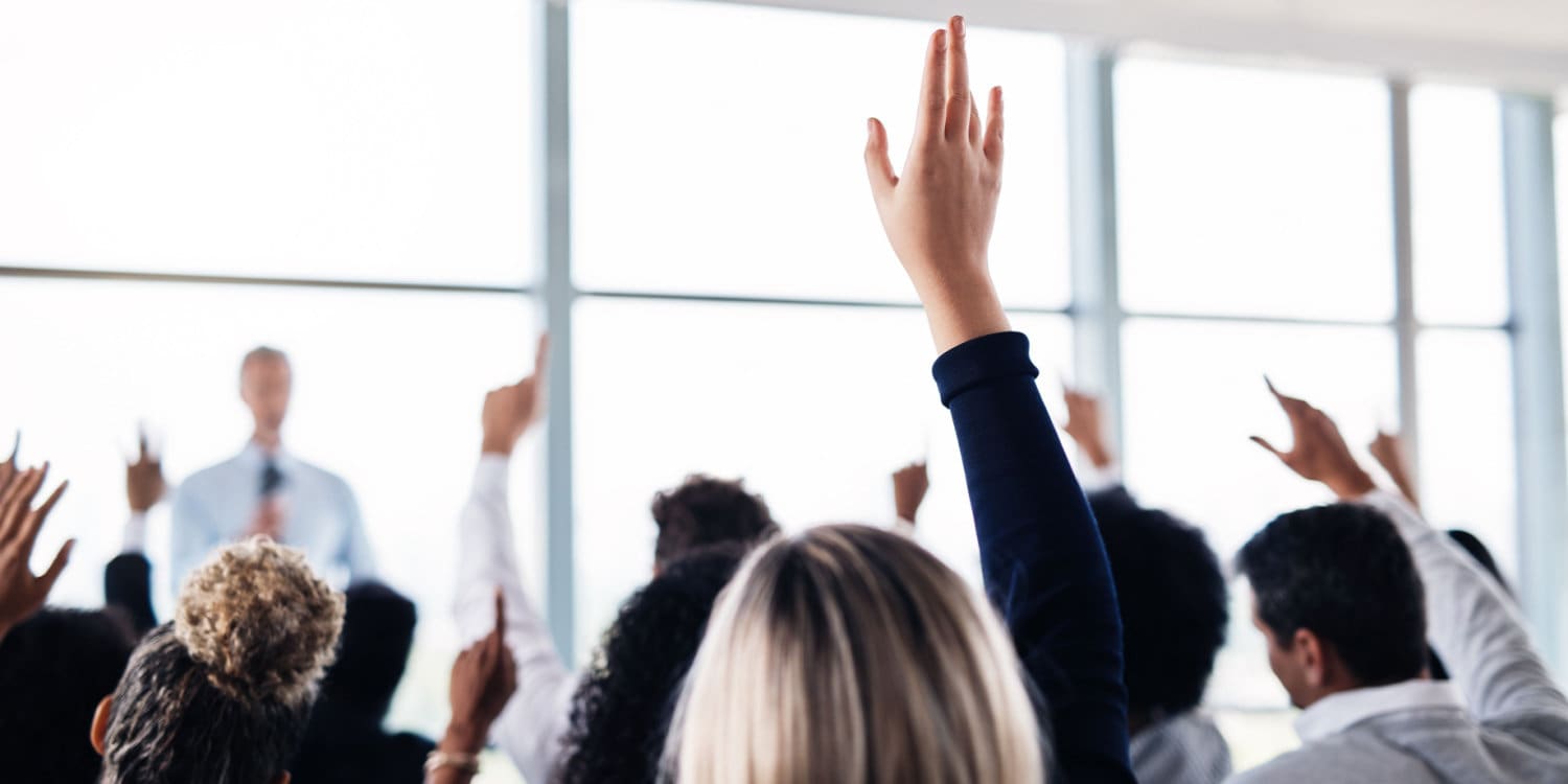 Members of a limited company casting their votes for or against a special resolution with a show of hands.