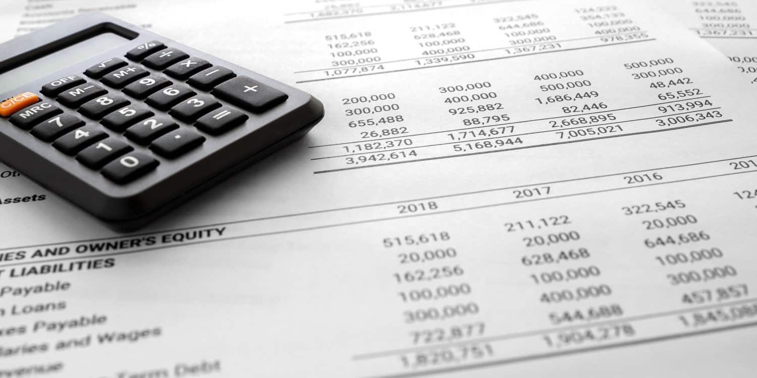 Annual accounts and calculator sitting on a desk.