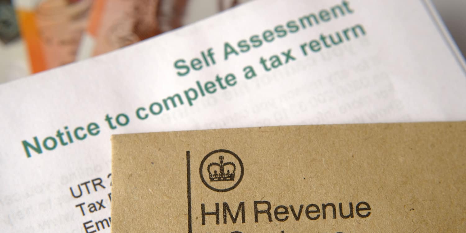 HM Revenue and Customs (HMRC) brown envelope and blurred Self Assessment tax return notice letter.