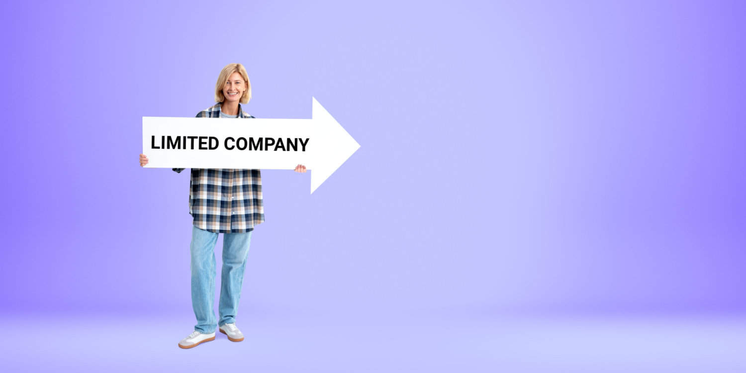 Smiling blonde female sole trader standing and holding a an arrow signboard in her hands that's displays the words 'LIMITED COMPANY'. Concept of converting from sole trader to limited comapny.
