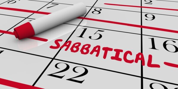 A zoomed-in shot of a paper calendar, where an employee has marked out many weeks of sabbatical leave in a red pen