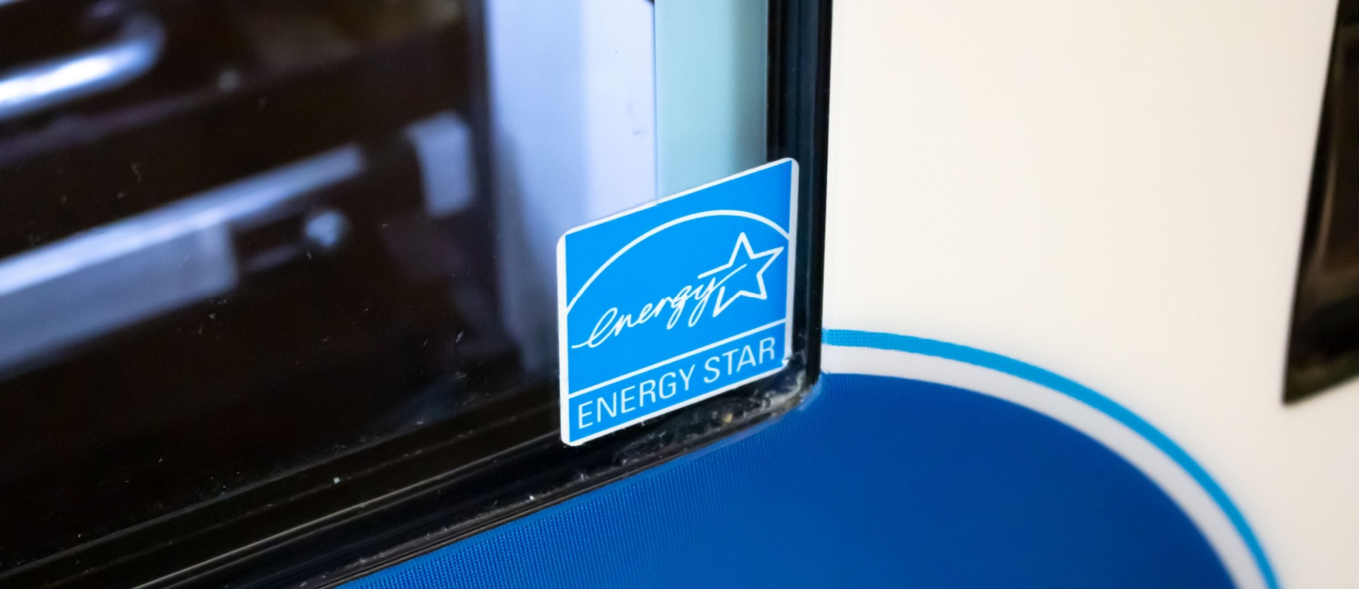 Corner of a laptop screen with a blue ENERGY STAR sticker illustrating that it meets energy-efficiency specifications