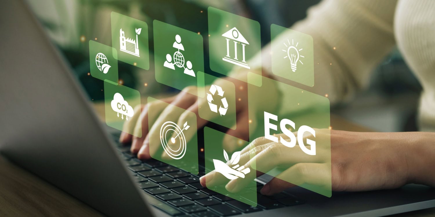 Person typing on a laptop with floating green ESG icons, including sustainability, carbon footprint reduction, recycling, and corporate responsibility, symbolising eco-friendly business practices and environmental social governance (ESG) initiatives