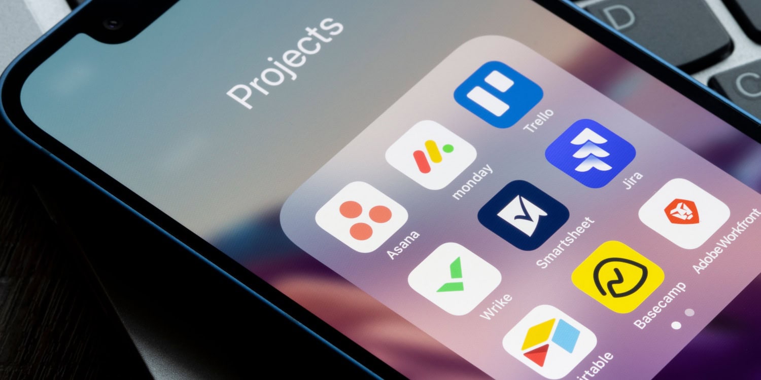 Close-up of a smartphone screen displaying a "Projects" folder with icons for Asana, Trello, and other project management apps.