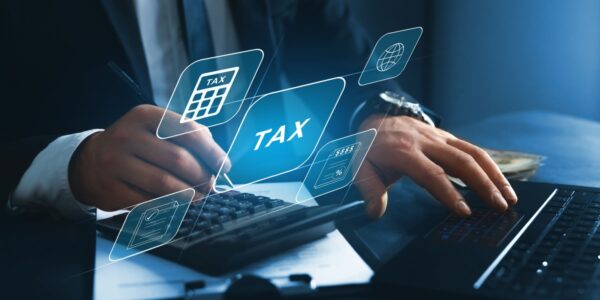 Businessman using a laptop to fill in the income tax online return.