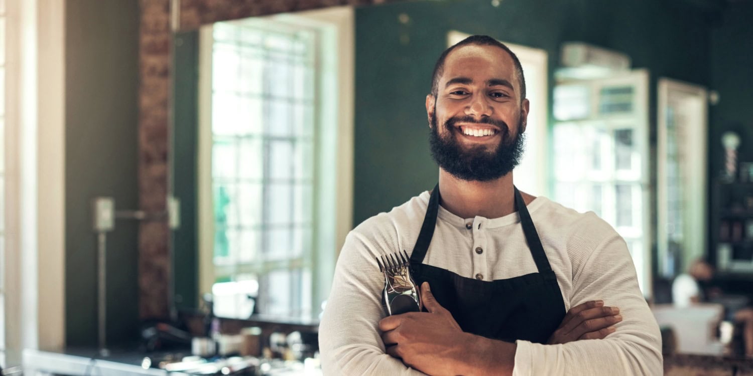 Man holding clippers who owns a barbershop: a great example of what an SME is.