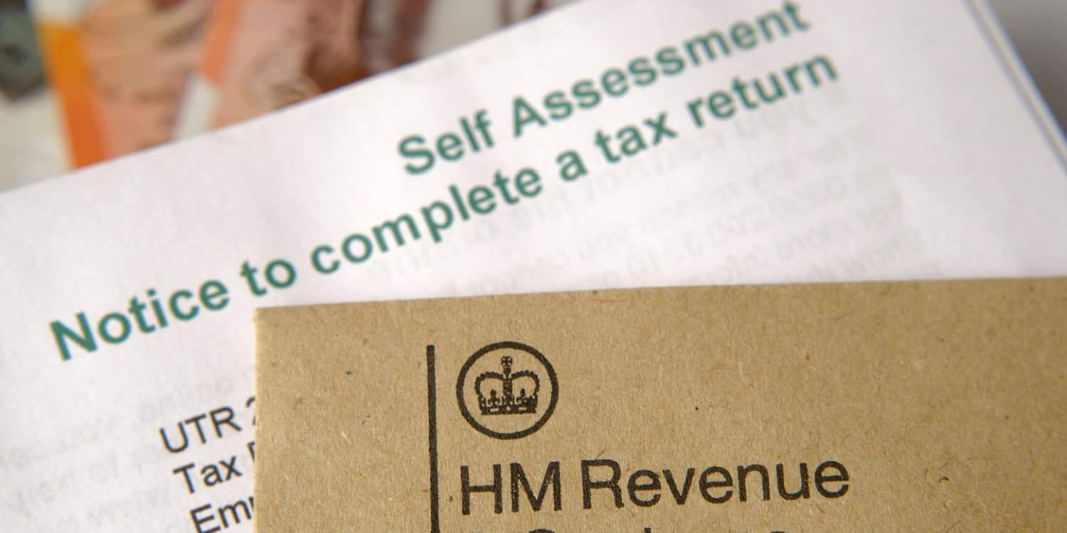 HM Revenue and Customs (HMRC) brown envelope placed on top of Self Assessment tax return notice letter.