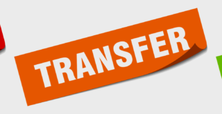 Orange sign with white letters displaying the word 'TRANSFER'.